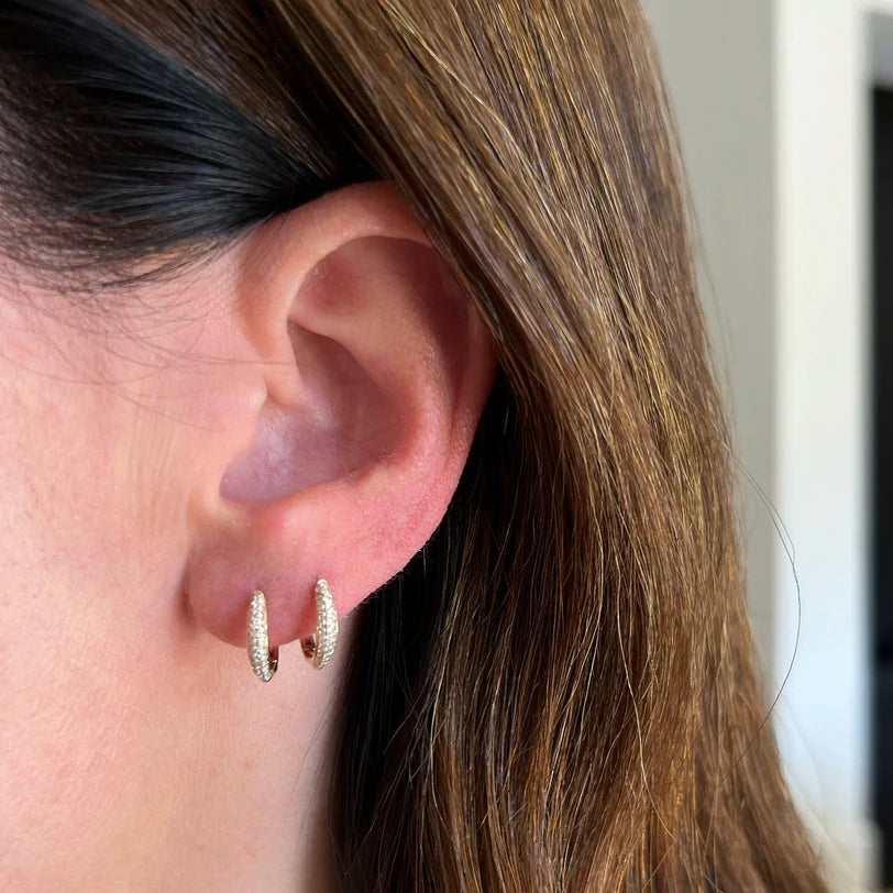 EF Collection Diamond Dome Huggie Earrings in yellow gold styled on models ear. 