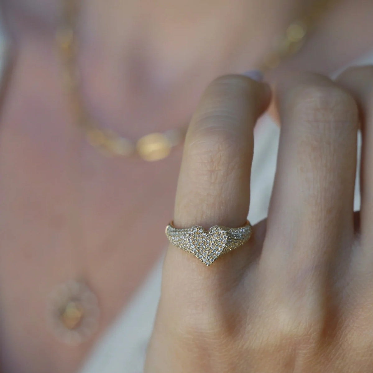 Close up of EF-Collection Diamond Heart Signet Ring in yellow gold on models finger