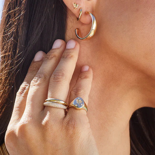EF Collection Diamond Hummingbird Signet Ring in yellow gold styled on model’s finger. 