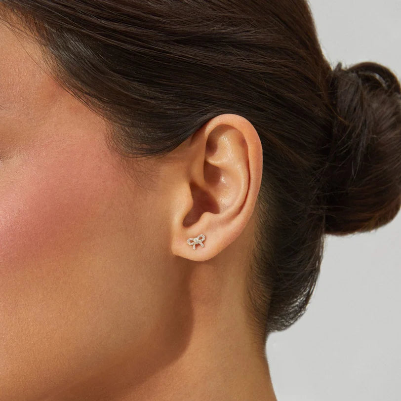 Single EF Collection Diamond Mini Bow Stud Earring in yellow gold styled on models ear. 