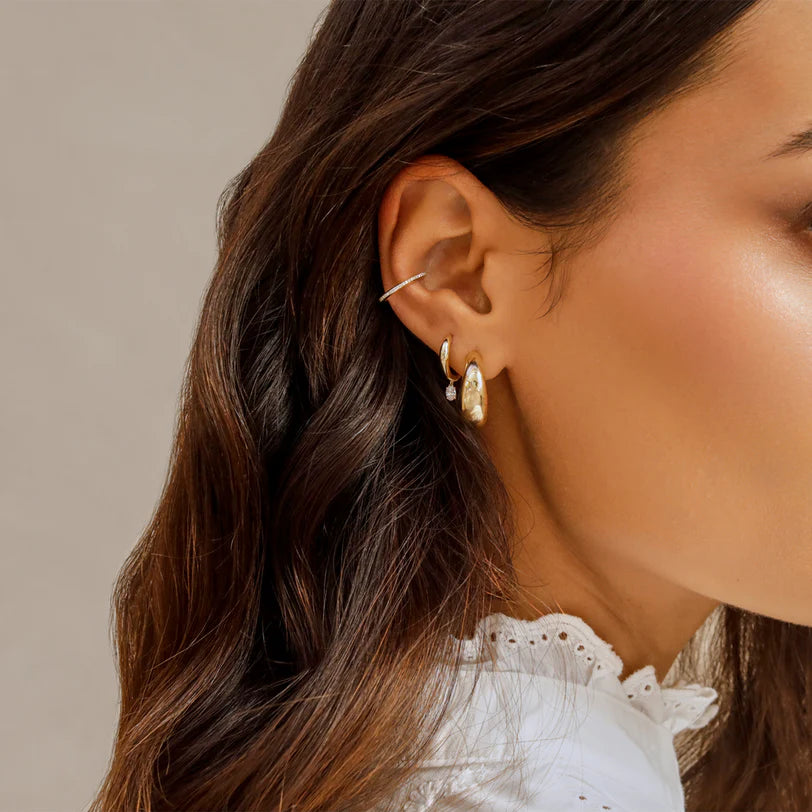 EF Collection Diamond Oval Drop Gold Dome Huggie Earring styled on models ear paired with a gold huggie. 
