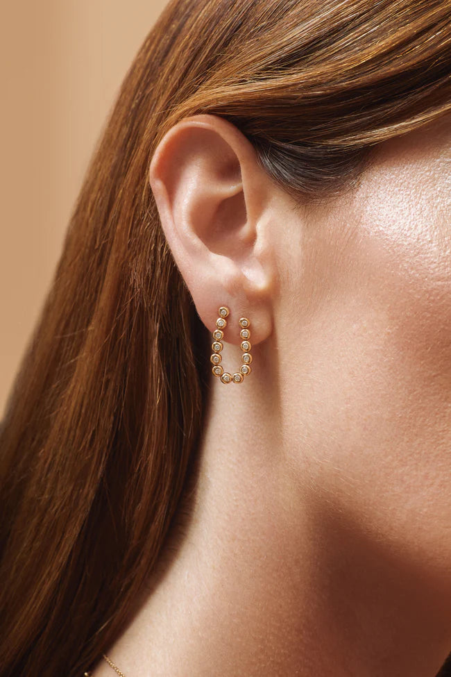 Single EF Collection Diamond Pillow Double Stud Earring in yellow gold on models ear. 