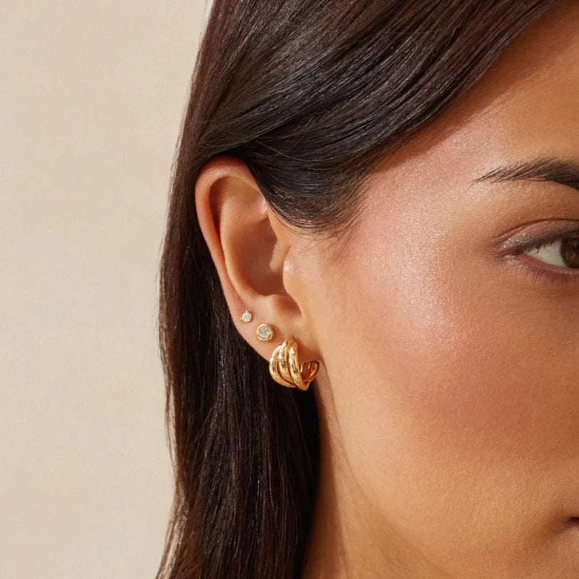 EF Collection Diamond Pillow Stud Earrings in yellow gold styled on models ear with a gold hoop. 