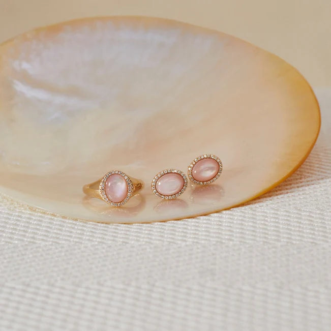 EF Collection Diamond & Pink Mother Of Pearl Cabochon Signet Ring in yellow gold on pearl surface with pink mother of pearl earrings. 