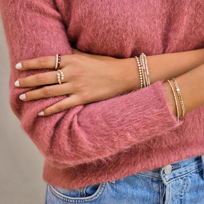 EF Collection Diamond Sari Bracelet in yellow gold on models wrist with other bracelets and rings. 