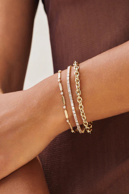 EF-Collection Diamond Zoe Eternity Bracelet in yellow gold on models wrist with two other bracelets