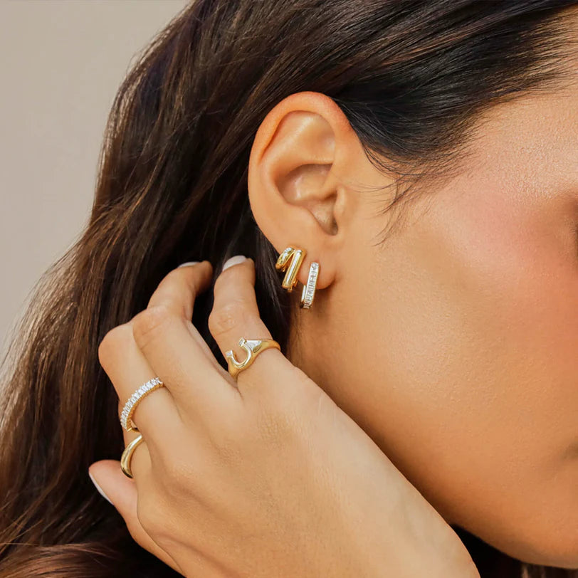 EF Collection Double Gold Jumbo Huggie Earring in yellow gold styled on models ear. 