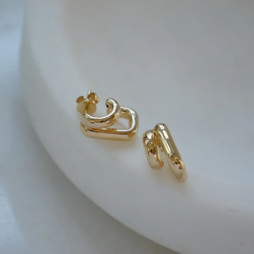 EF Collection Double Gold Jumbo Huggie Earring in yellow gold on styled white background. 