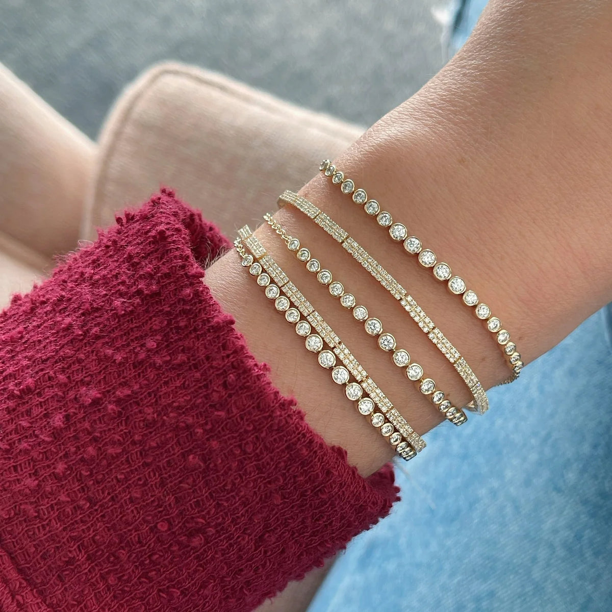 EF-Collection Double Row Diamond Tennis Bracelet in yellow gold styled on models wrist wearing a red long sleeve 