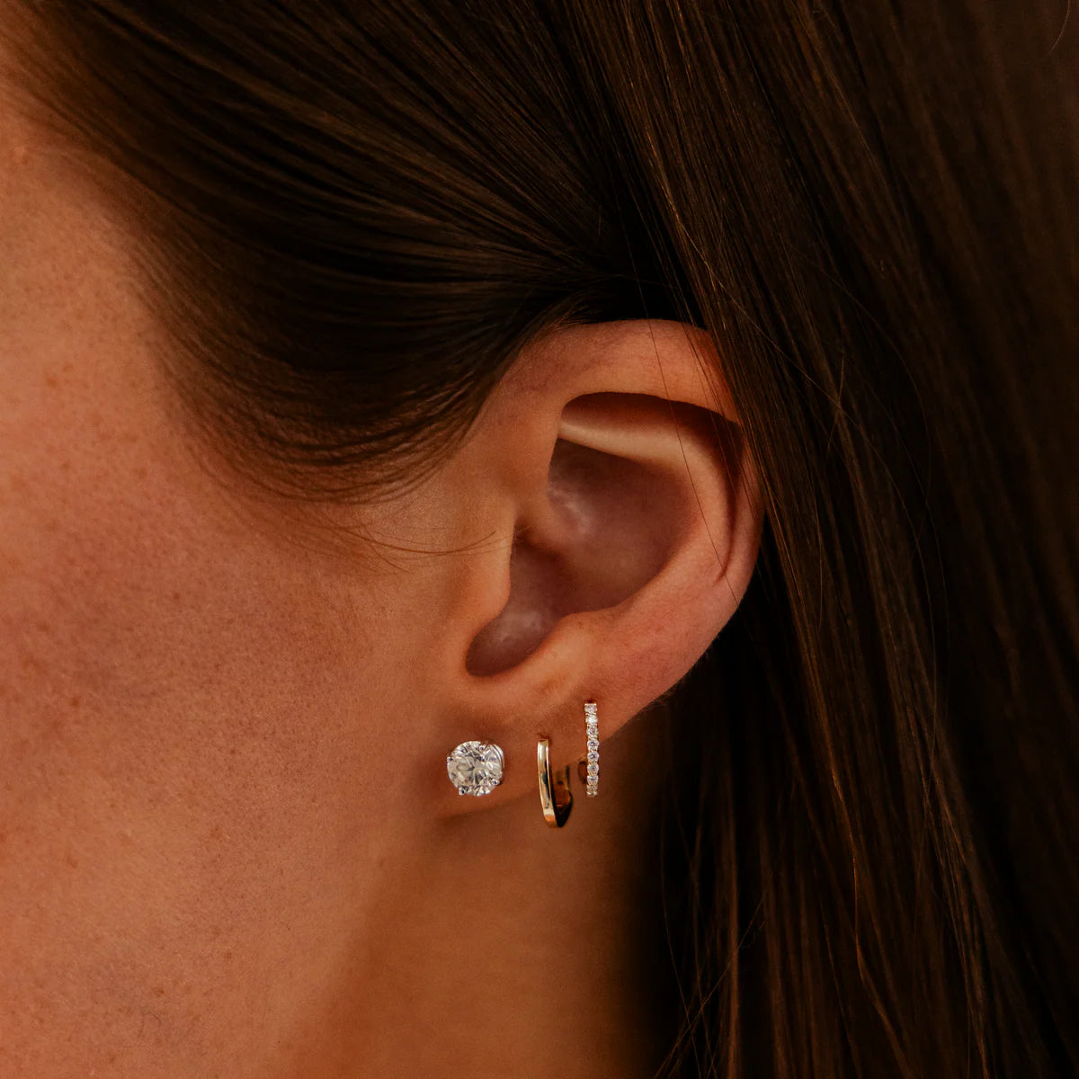 Dana Rebecca Designs Yellow Gold Diamond Huggies on an ear 
