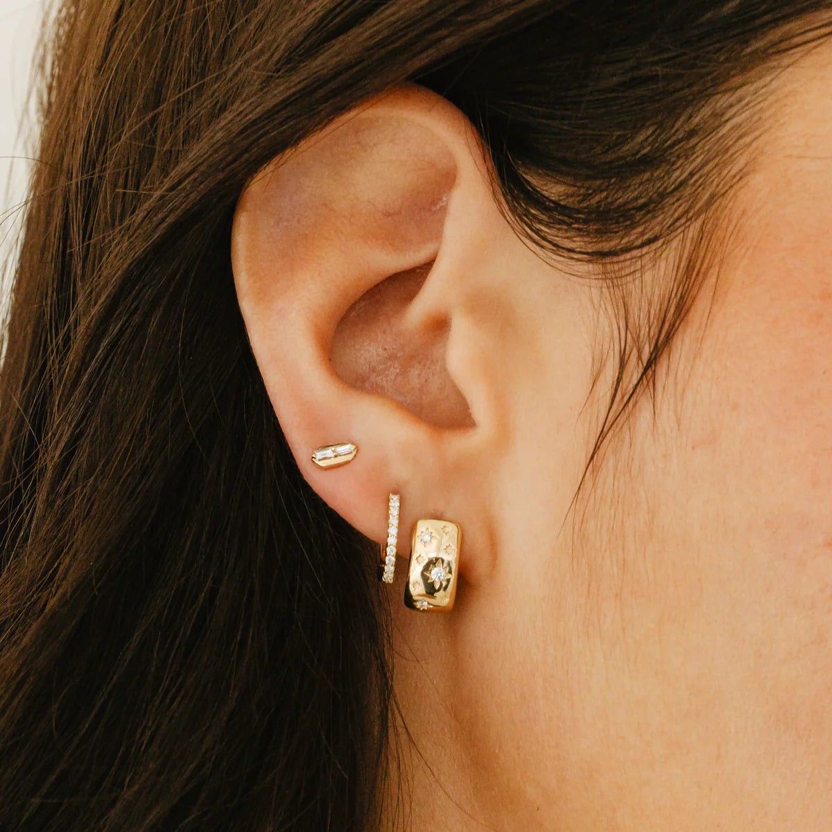 Dana Rebecca Designs DRD Medium Huggies in yellow gold styled on models ear 