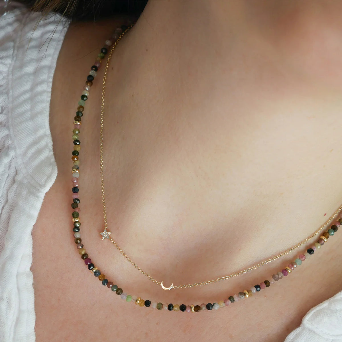 EF-Collection Birthstone Bead Necklace In Tourmaline in yellow gold styled on models neck with star and moon necklace