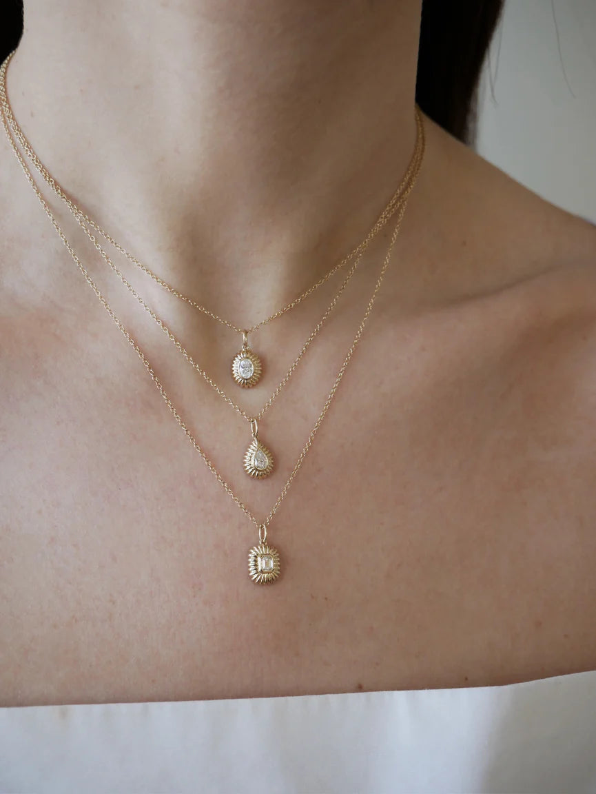 EF-Collection Fluted Emerald Cut Diamond Charm in yellow gold on models neck with other fluted diamond charms 