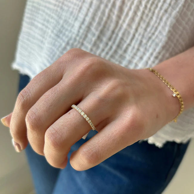 Single EF Collection Full Cut Diamond Arc Ring in yellow gold on model’s finger.