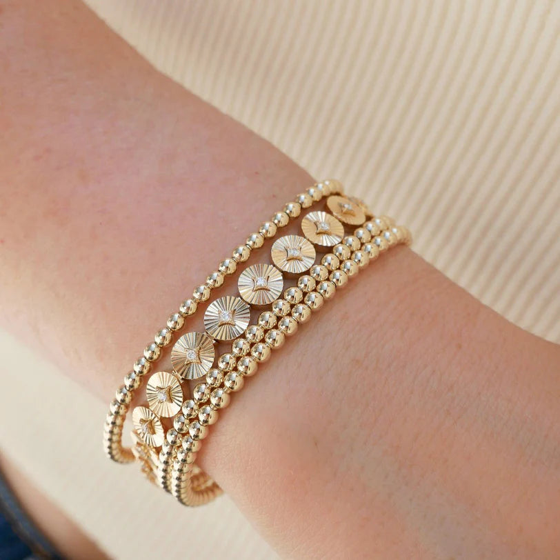 Close up of EF Collection Gold & Diamond Fluted Disc Eternity Bracelet in yellow gold on models wrist