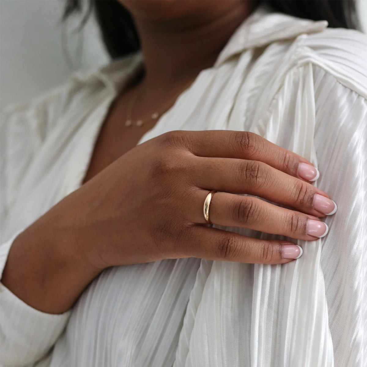 Single EF Collection Gold Dome Ring in yellow gold on model’s finger. 