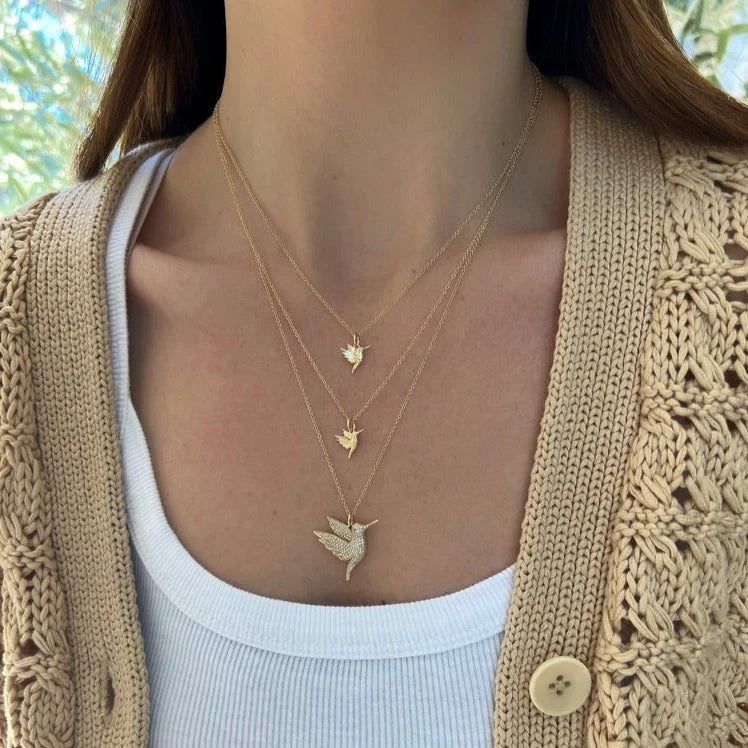 EF-Collection Gold Hummingbird Charm Necklace in yellow gold on models neck in three different sizes