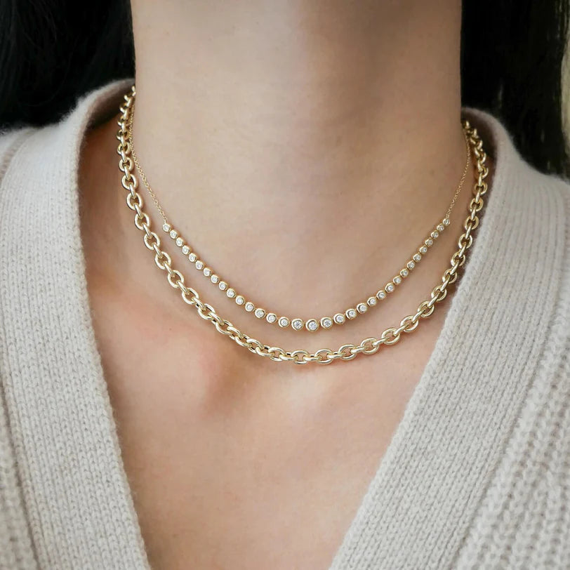 EF Collection Graduated Diamond Pillow Necklace in yellow gold on models neck styled with gold chain necklace. 