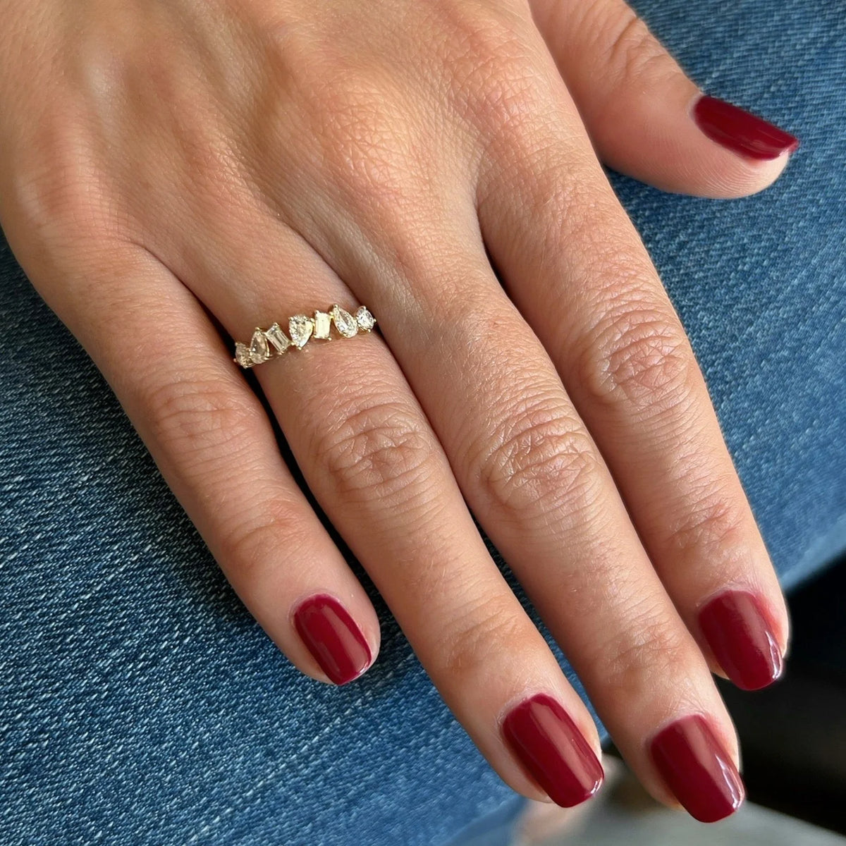 Single EF Collection Jumbo Multifaceted Diamond Ring in yellow gold on model’s finger with red nails. 