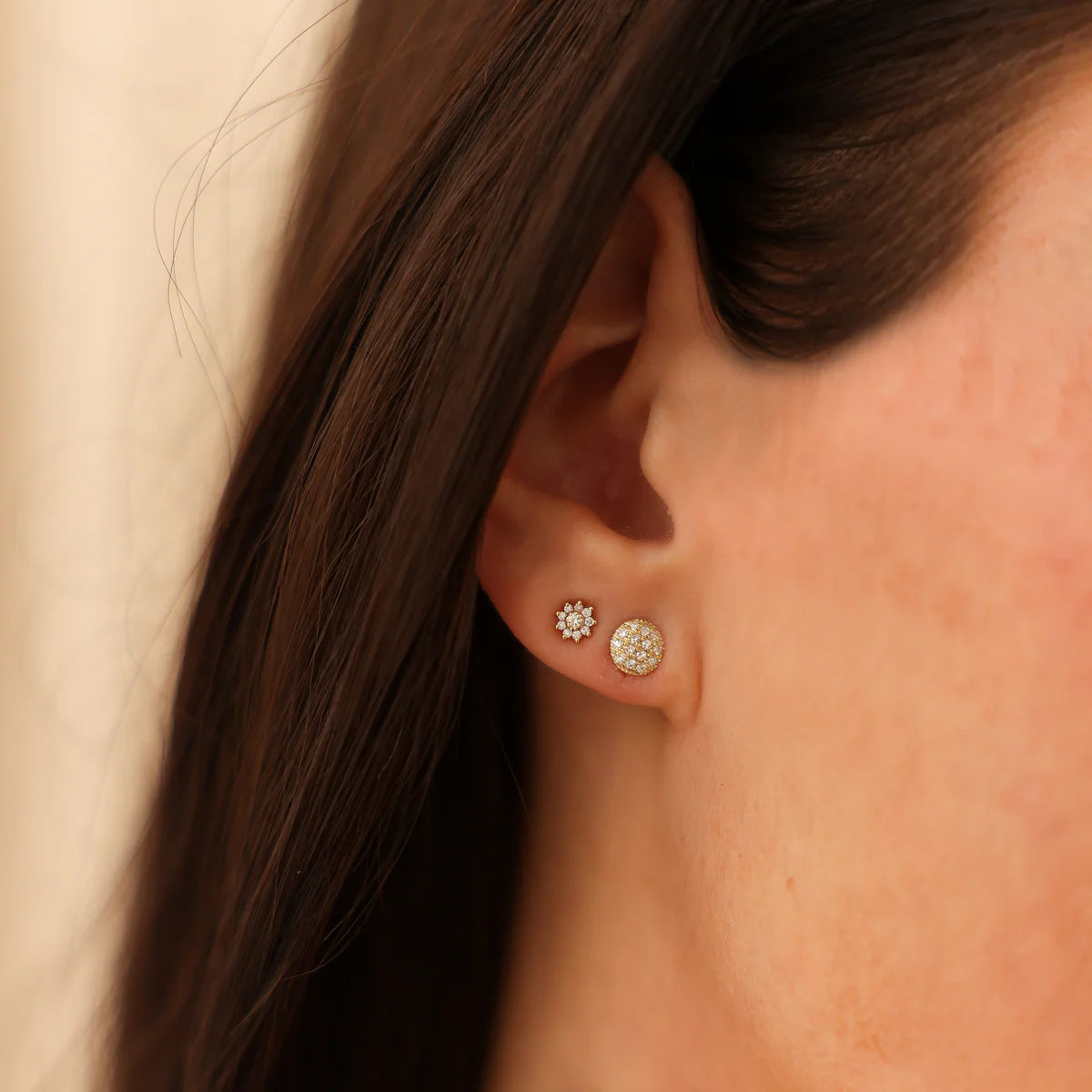 close up of Lauren Joy Mini Disc Studs in Yellow Gold styled with other studs on ear