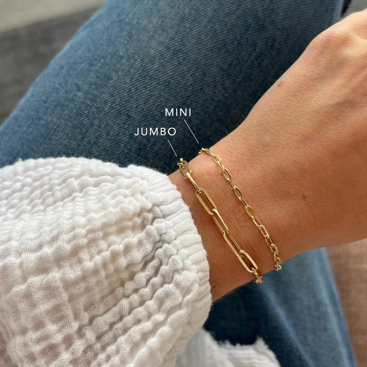EF-Collection Mini Link Chain Bracelet in yellow gold on models wrist comparing the size of the jumbo link chain bracelet 