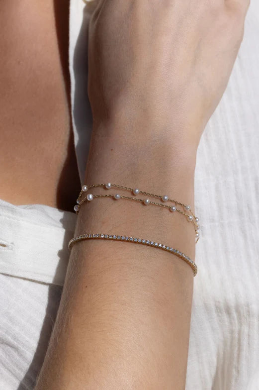 EF Collection Multi Pearl Double Chain Bracelet in yellow gold styled on model's wrist. 