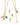 Set of gold necklaces with colorful Onirikka enamel charms on a white background