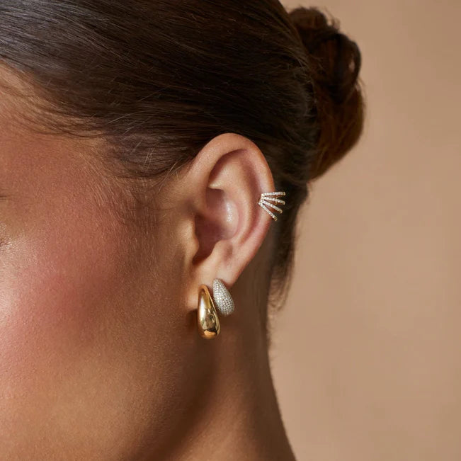 EF Collection Pavé Diamond Jumbo Dome Huggie Earrings in yellow gold models ear. 