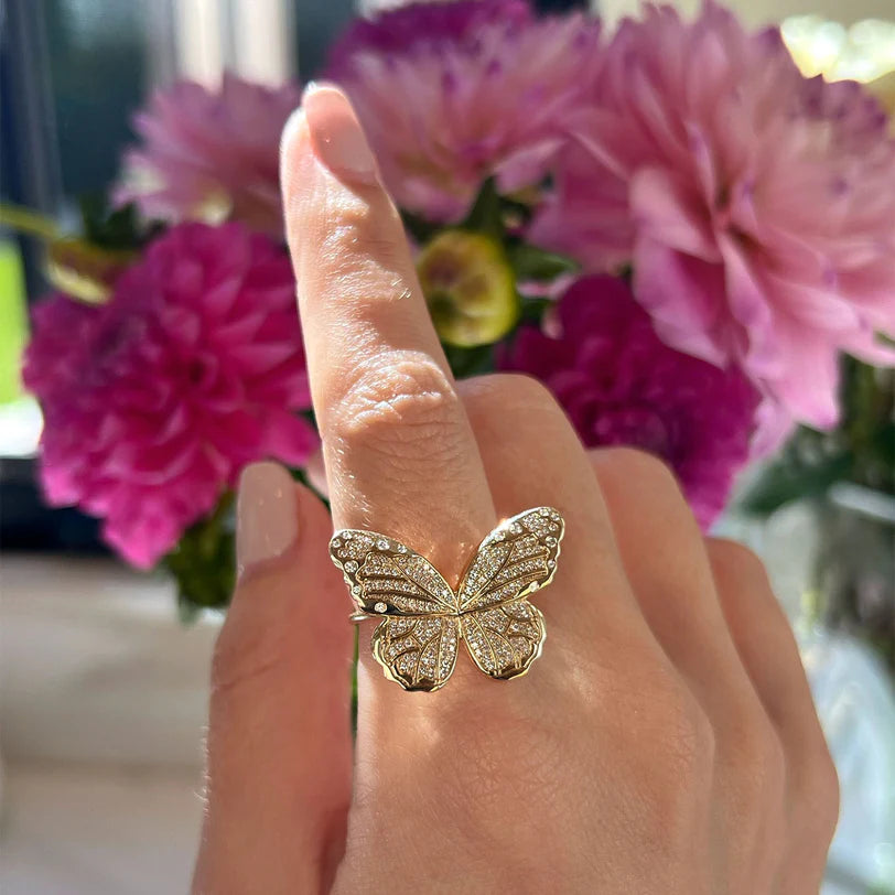 Close up of EF Collection Pavé Diamond Jumbo Butterfly Ring in yellow gold on model’s finger. 