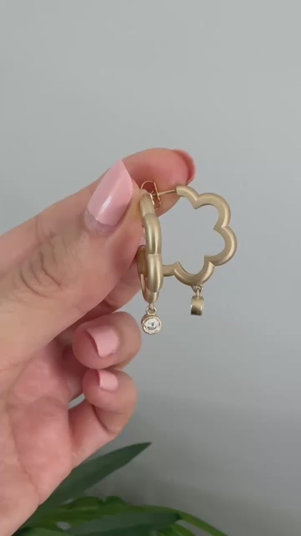 close up video of Onirikka Floret hoop earrings with a diamond drop in yellow gold