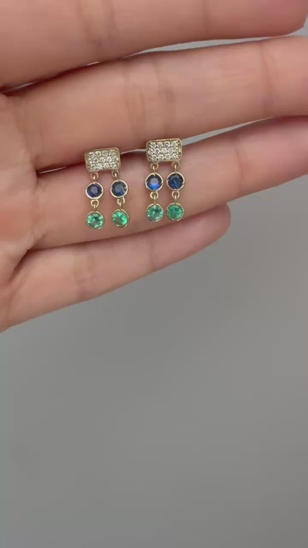 Product video of Onirikka Petite Caviar Earrings with diamonds, Emeralds and blue sapphire in yellow gold.