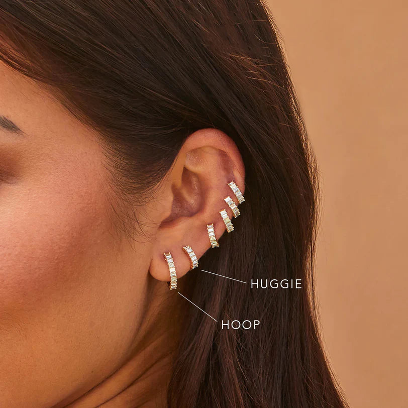 EF-Collection Prong Set Diamond Baguette Huggie Earrings in yellow gold on models ear comparing the hoop and the huggie 
