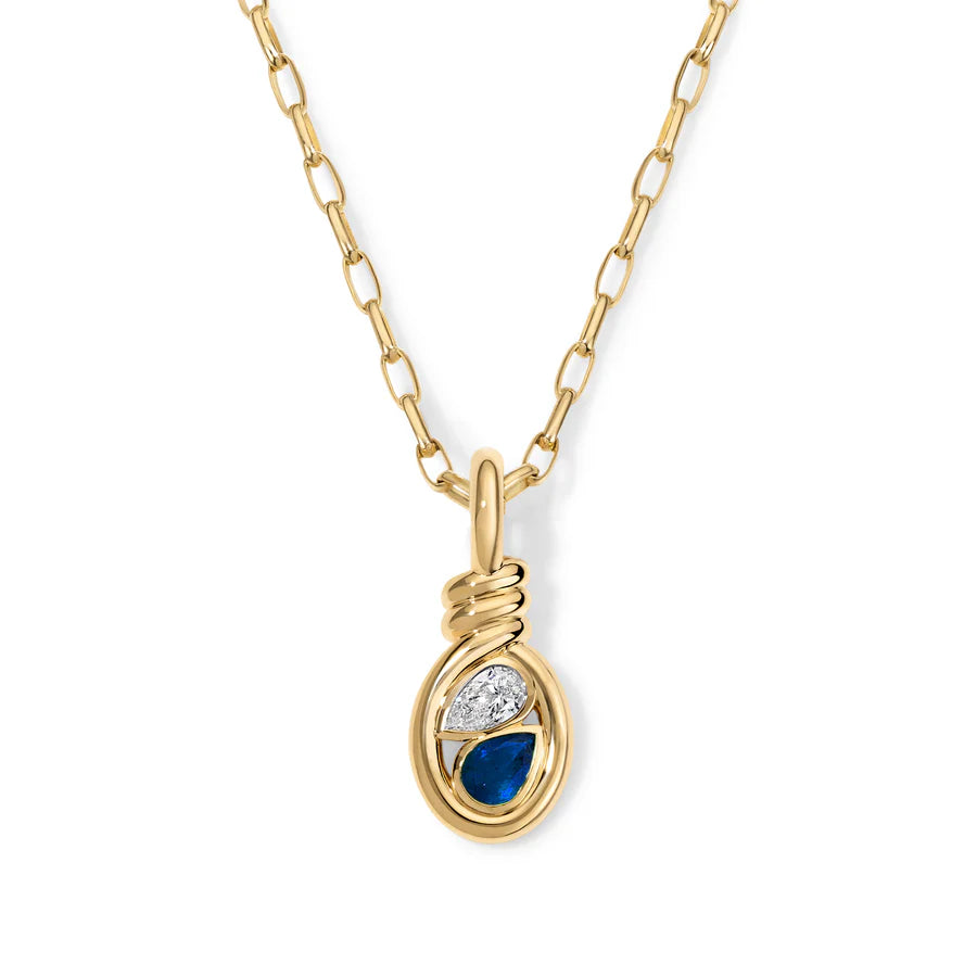 Rosario Navia Twist Two-Stone Pendant Diamond & Blue Sapphire in yellow gold on white background 