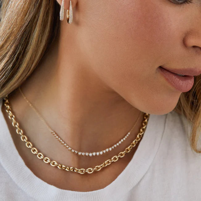 EF-Collection Sienna Chain Necklace in 14k gold, styled on models neck with a half tennis necklace and diamond drop earrings