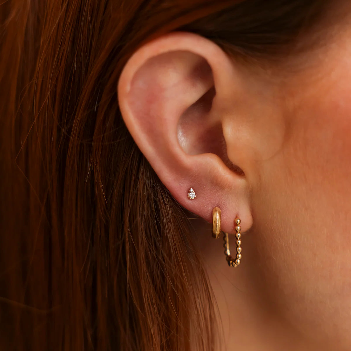 close up of Dana Rebecca Designs Sophia Ryan Petite Teardrop studs in rose gold on model