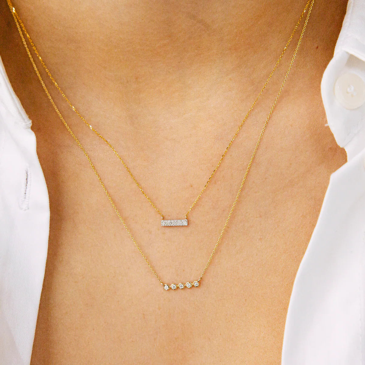 close up of Dana Rebecca Designs Diamond Sylvie Rose Bar Necklace with a yellow gold chain and diamonds
