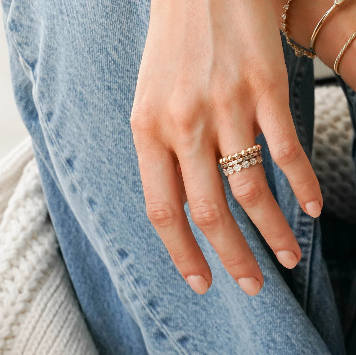 Dana Rebecca Designs Taylor Beth Eternity Band Ring in yellow gold styled on models finger with jean background 