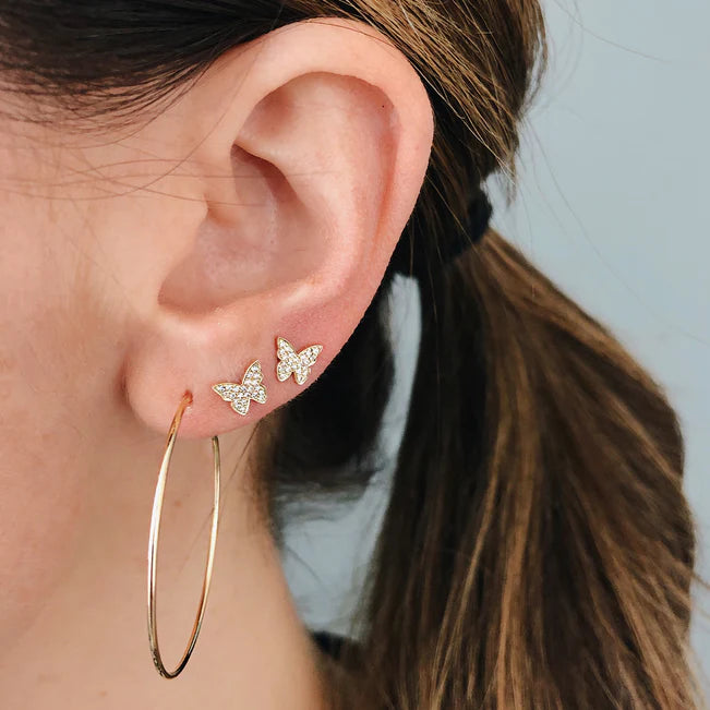 EF Collection The Perfect Gold Hoop Earrings styled in yellow gold on models ear with brunette hair. 