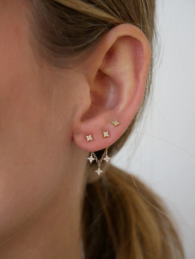 EF Collection Triple Diamond Sparkle Stud Earring Charm with Sparkle Studs in yellow gold styled on models ear. 