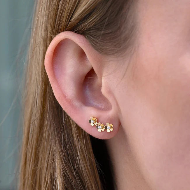 Single EF Collection Triple Gold and Diamond Mini Cherry Blossom Ear Climber in yellow gold styled on models ear. 