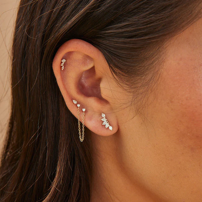 Single EF Collection Triple Marquise Stud Earring in yellow gold layered on models ear. 