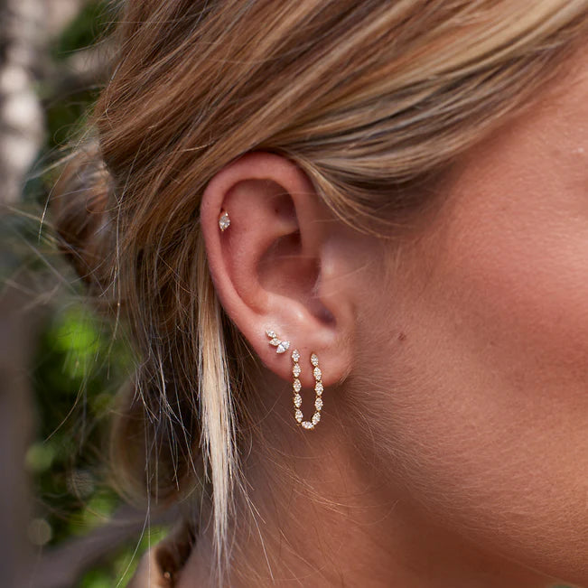 Close up of EF Collection Triple Marquise Stud Earring in yellow gold models ear. 