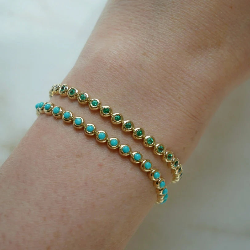 EF Collection Turquoise & Diamond Pillow Eternity Bracelet and Emerald & Diamond Pillow Eternity Bracelet  in yellow gold on models wrist. 